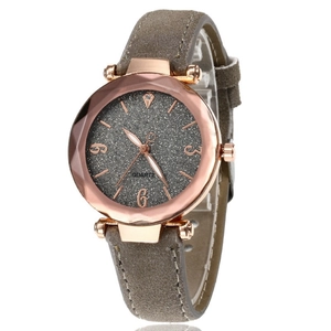 Detailed close-up of rose gold polygonal case and grey glitter dial on quartz watch