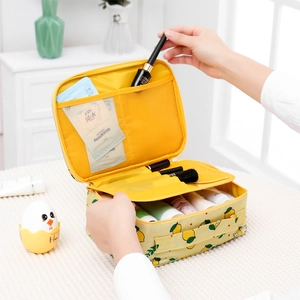 Detail of yellow lemon cosmetic bag featuring internal mesh pockets and brush slots