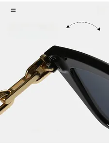 Close-up of durable metal hinge with stylish gold chain link design on square sunglasses