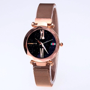 Detail of rose gold Milanese mesh strap watch with starry dial and striped design