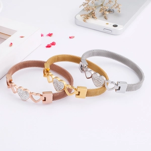 Three fashion mesh bangles in gold, rose gold and silver with zircon heart charms