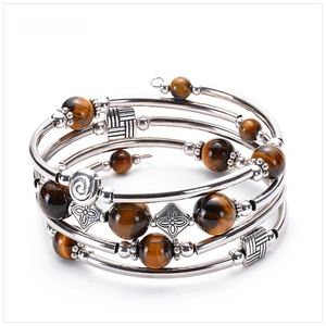 Detail of multi-layer tiger eye stone beads and silver spiral metal tubing on wrap bracelet
