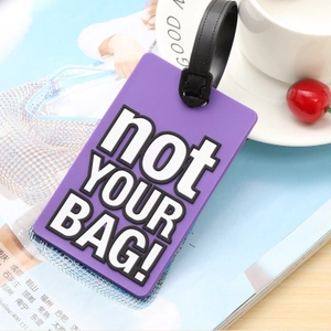 Durable purple PVC luggage tag with black strap featuring bold not YOUR BAG print