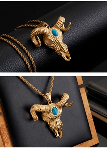 Macro detail of golden ram skull pendant with turquoise stone inlay and twist chain