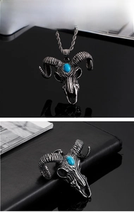 Detail of vintage goat head skull pendant with blue stone inlay and braided chain