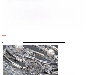 Detailed macro view of white crystal wrap bracelet with silver tree of life charm