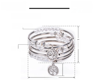 Detail of multi-layer wrap bracelet with white crystals, pearls and tree of life charms