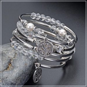 Close-up of white crystal multi-layer wrap bracelet with tree of life charm and pearls