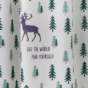 Detail of deer and pine tree prints on beige linen fabric with English text quote