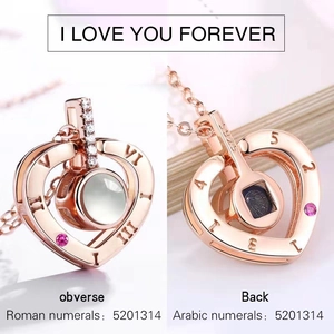 Macro detail of S925 heart necklace showing numeric engravings and pink gemstone inlay
