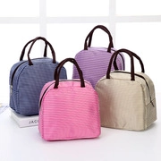 Detail view of colorful polka dot lunch bags in blue, pink, purple, and beige linen fabric