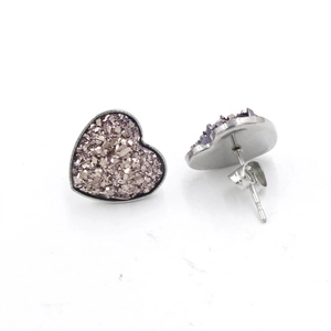 Close-up of pink heart-shaped druzy crystal earrings with polished metal backing