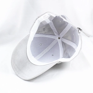 Detail view of the grey suede baseball cap inner lining with white sweatband and label