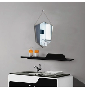 Detail view of a Nordic hexagonal gold brass mirror with a minimalist hanging cord