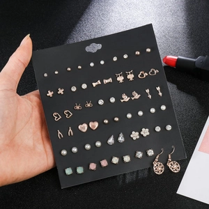 Detailed view of colorful heart, bow, and owl stud earrings set with zircons and pearls