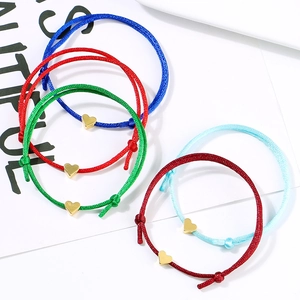 Detailed view of five adjustable heart bracelets in blue, red, green and burgundy