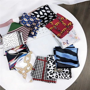 Various patterned silk scarves collection with polka dots and floral prints on white surface