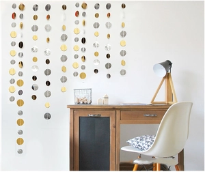 Detail of hanging gold, silver, and black paper circle garland party backdrop decoration