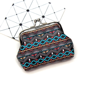 Detail view of ethnic geometric print on vintage leather coin purse with metal clasp
