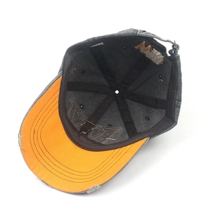 Gray washed denim baseball cap with orange brim underside and adjustable metal buckle