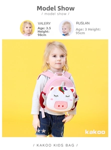 Pink unicorn kids backpack with rainbow accents shown on a child model with dimensions