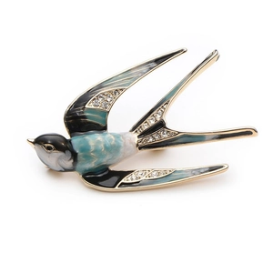 Elegant swallow brooch with enamel wings and sparkling rhinestones on a gold base