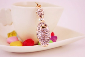 Detailed close-up of a sparkling gold bowling pin keychain with inlaid rhinestones