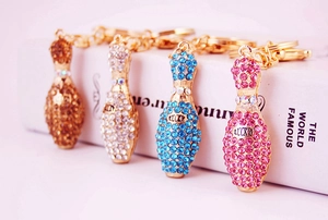 Detailed close-up of lucky crystal bowling pins keychains in four vibrant colors