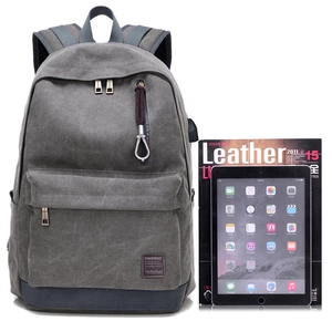 Zaino in tela grigia con base blu e porta USB mostrato con tablet come riferimento di misura