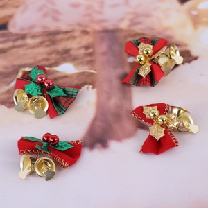Close-up of mini Christmas tree bows with festive bells and holiday greenery details
