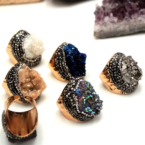 Close-up of colorful druzy agate crystal rings with gold plated rhinestone frames