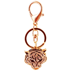 Sparkling gold tiger head keychain with white crystals and black enamel details