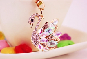 Macro view of golden swan keychain featuring sparkling crystals and iridescent marquise stones