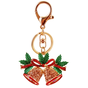 Christmas rhinestone bell keychain with green leaves and red bow on white background