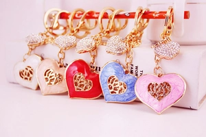 Detail of colorful enamel heart keychains with small rhinestone pendants in five shades