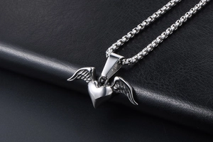 Detailed shot of silver heart pendant with wings on a steel box chain necklace