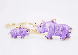 Detailed view of purple enamel rhinoceros keychain with crystal accents and gold-tone chain