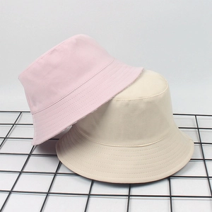 Detail of pink and beige cotton bucket hats with reinforced stitching on wire mesh