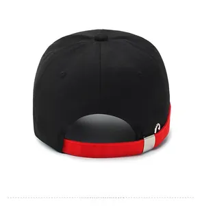 Detail of baseball cap back with black cotton fabric and adjustable red strap with metal buckle