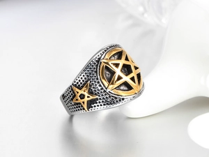 Detail of vintage punk titanium steel ring with textured silver finish and golden stars