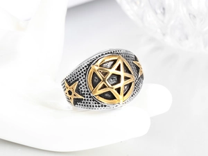 Detail of a gothic punk ring showing gold star icons and honeycomb textures