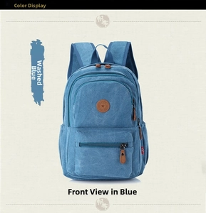 Front detail of washed blue canvas backpack with leather zip pullers and logo