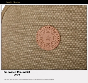 Detailed close-up of the leather star logo on the khaki washed canvas backpack fabric