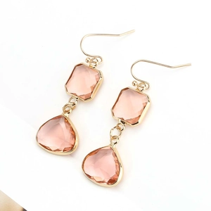 Detailed view of champagne pink drop earrings with golden frames and faceted crystals