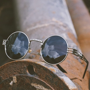 Retro steampunk round polarized sunglasses with silver engraved metal frame on industrial pipe