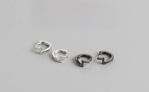 Macro detail of 9mm S925 sterling silver lightning bolt hoop earrings in silver and gun black