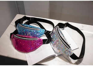 Close-up of holographic sequin waist bags in blue, pink, and silver with adjustable straps