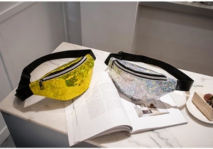 Detail of gold and holographic silver sequin fanny packs on a white marble surface