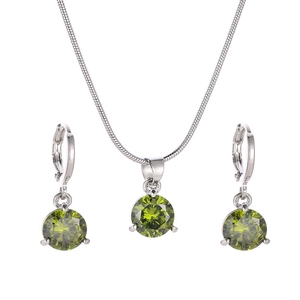 Détail d'un ensemble de bijoux en argent avec des pendentifs en zircon vert rond