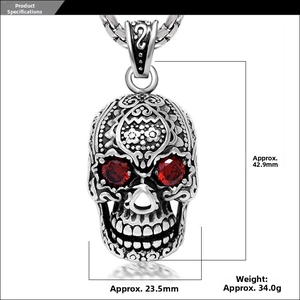 Detail of retro skull pendant with red stone eyes showing dimensions 42.9mm and 23.5mm